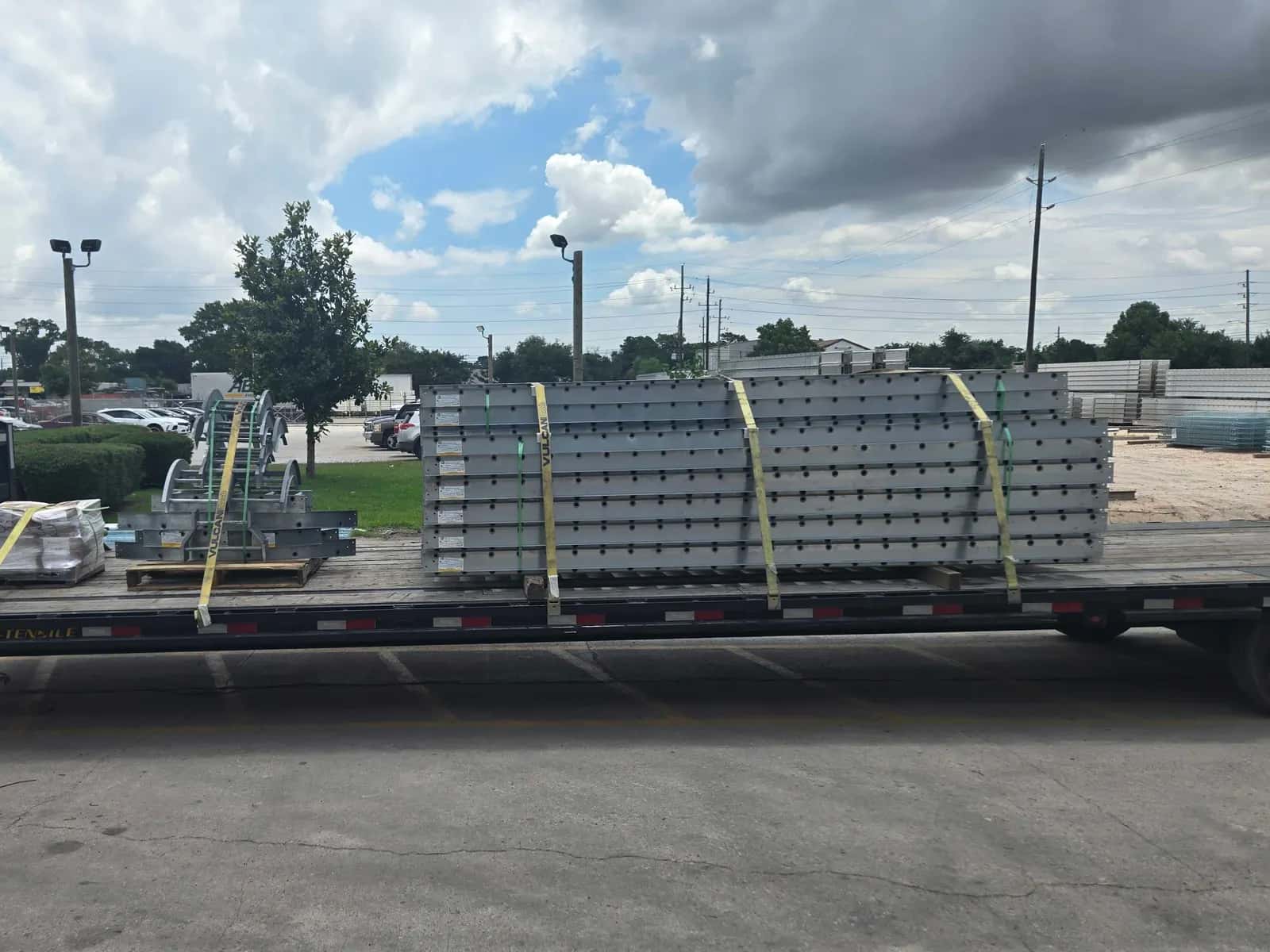 Steel components strapped to a gooseneck flatbed trailer