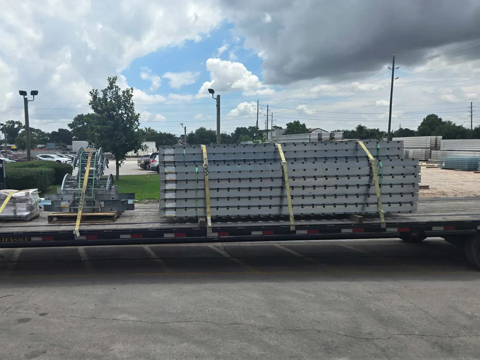 Steel components strapped to a gooseneck flatbed trailer